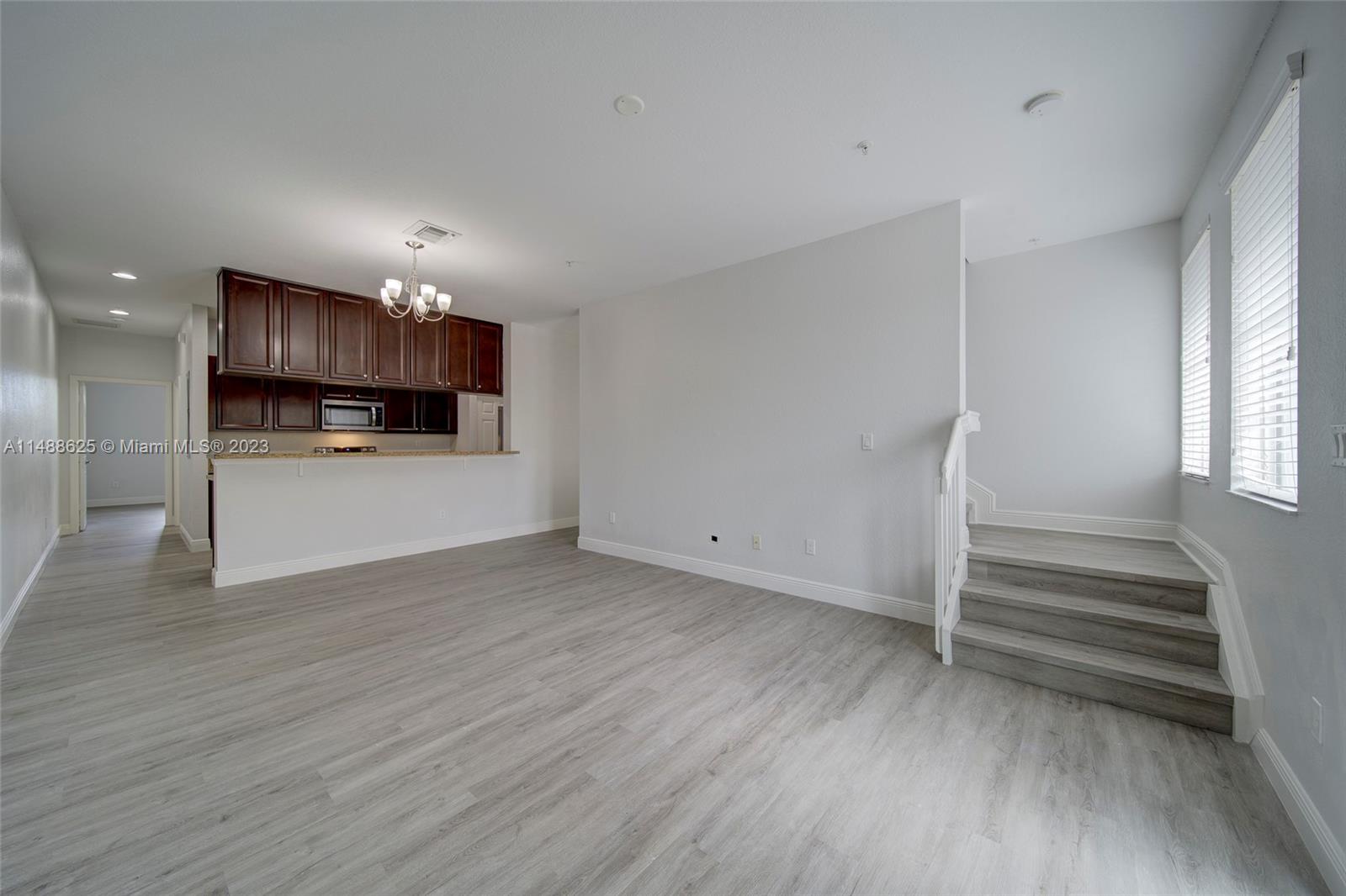14679 Southwest 9th Street, Unit 1801 Pembroke Pines, FL 33027 - Photo 8 of 26 a view of kitchen and wooden floor