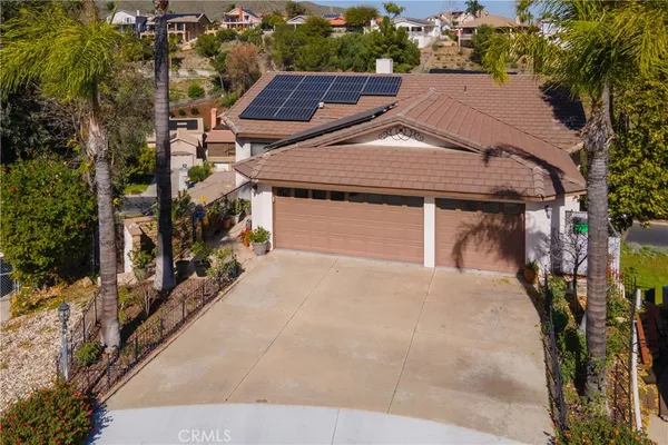 an aerial view of a house with a garden and mountain view