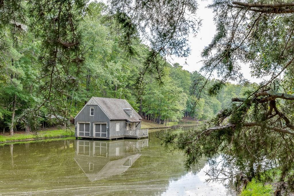 5755 Kennedy Road Buford, GA 30518 - Photo 12 of 23 a aerial view of a house next to a lake with large trees