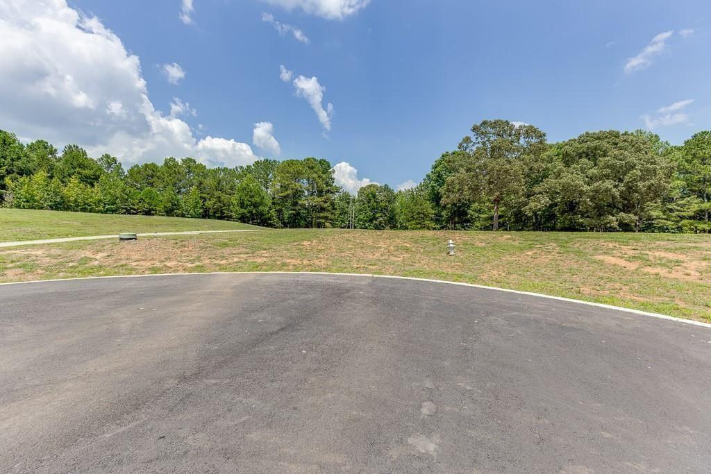 5755 Kennedy Road Buford, GA 30518 - Photo 2 of 23 a view of a big yard with palm trees