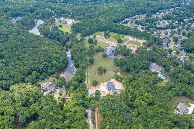 an aerial view of a house with a yard