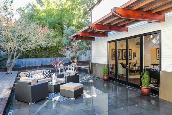 14480 Oak Place Saratoga, CA 95070 - Photo 31 of 50 a view of a patio with a dining table and chairs under an umbrella with a barbeque