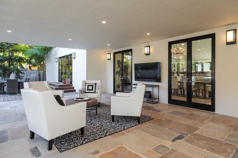 14480 Oak Place Saratoga, CA 95070 - Photo 33 of 50 a living room with furniture a flat screen tv and a floor to ceiling window
