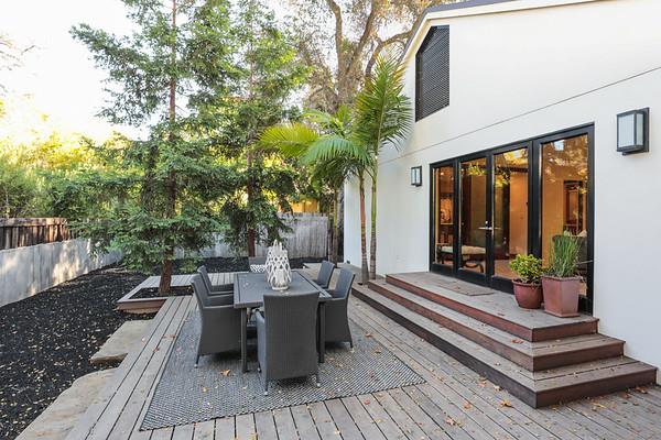14480 Oak Place Saratoga, CA 95070 - Photo 35 of 50 a view of a patio with couches table and chairs and potted plants with wooden floor and fence