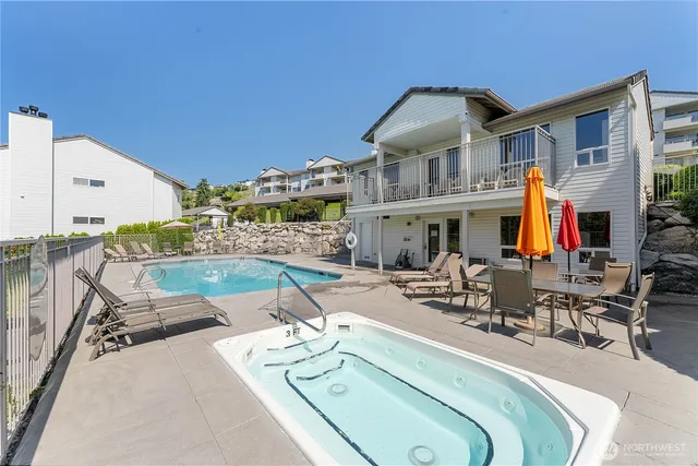 a view of a patio with swimming pool table and chairs