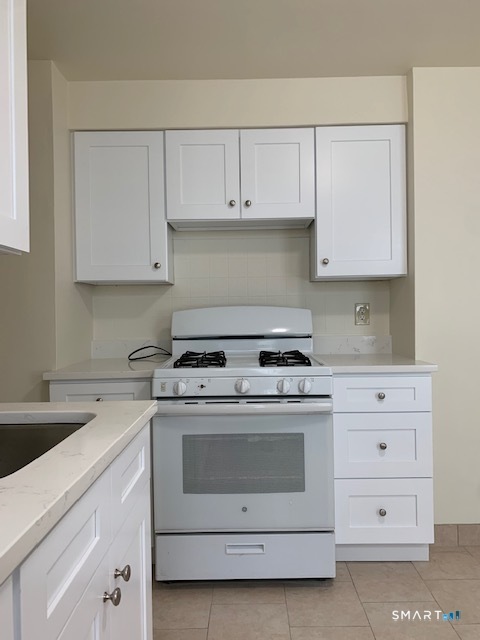 18 Lawrence Street Norwalk, CT 06854 - Photo 6 of 31 a white stove top oven sitting inside of a kitchen