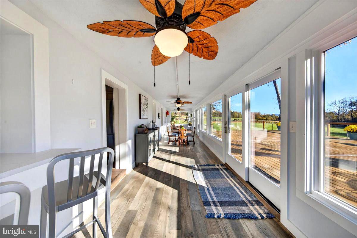 290 Riley Hollow Road Huntly, VA 22640 - Photo 54 of 148 a view of a dining room with furniture a chandelier large windows and wooden floor