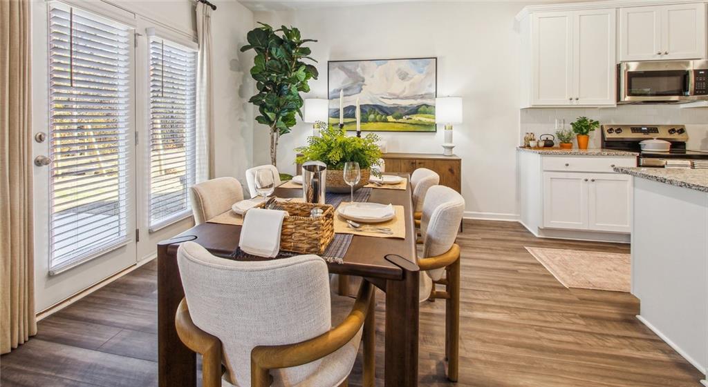 3373 Fence Road Northeast, Unit D4 Dacula, GA 30019 - Photo 25 of 40 a dining room with furniture and wooden floor