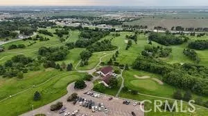 an aerial view of green landscape with trees houses and lake view