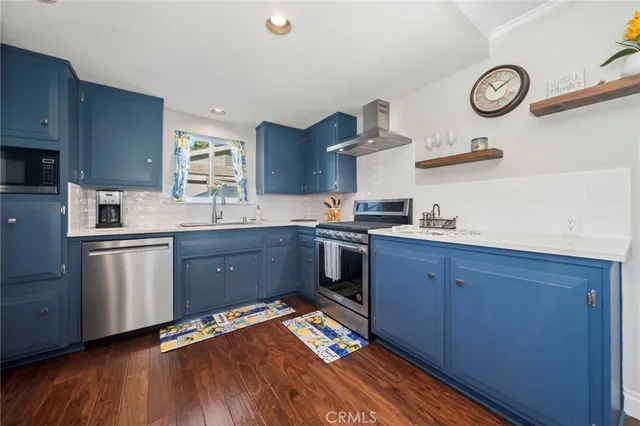 a kitchen with granite countertop stainless steel appliances and wooden cabinets