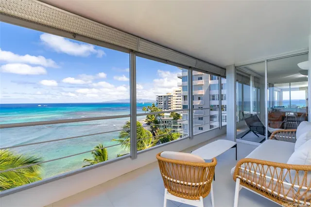 a living room filled with furniture and a floor to ceiling window