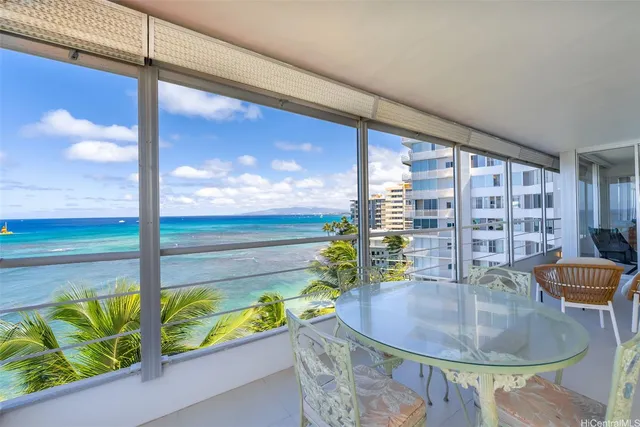 a dining room with furniture and a potted plant