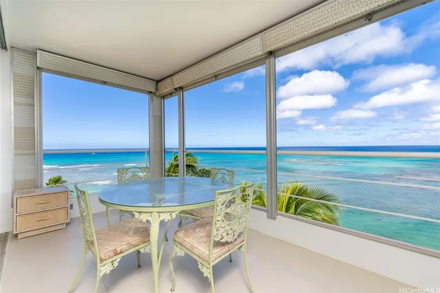 a dining room with furniture and floor to ceiling windows