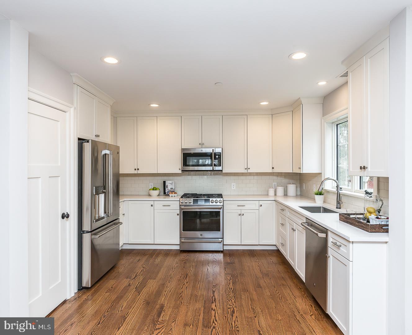 111 West Montgomery Avenue, Unit 107 Ardmore, PA 19003 - Photo 12 of 44 a kitchen with a refrigerator stove top oven and sink