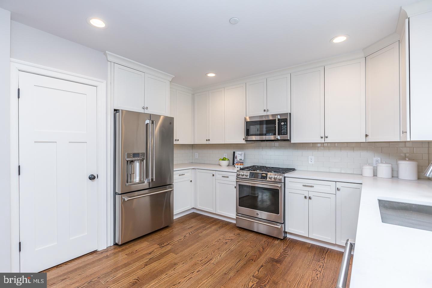 111 West Montgomery Avenue, Unit 107 Ardmore, PA 19003 - Photo 13 of 44 a kitchen with a refrigerator stove and wooden cabinets