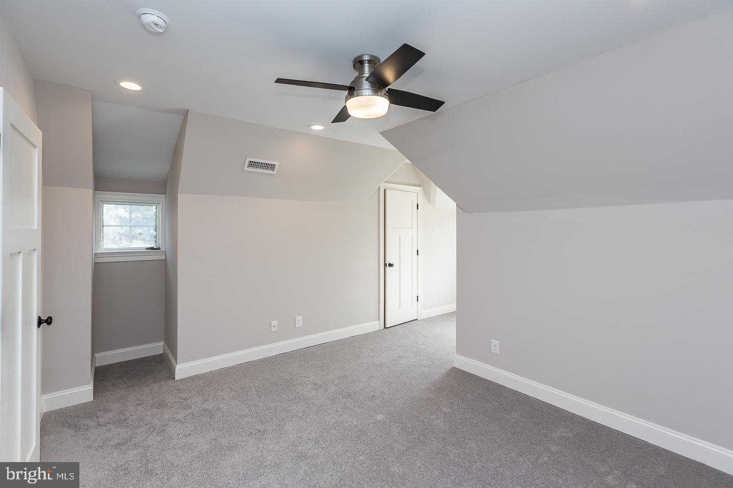 111 West Montgomery Avenue, Unit 107 Ardmore, PA 19003 - Photo 19 of 44 an empty room with a ceiling fan and a window