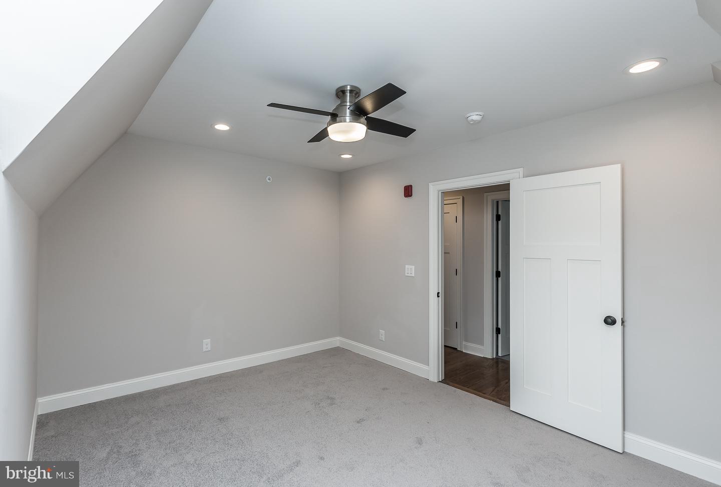 111 West Montgomery Avenue, Unit 107 Ardmore, PA 19003 - Photo 21 of 44 an empty room with ceiling fan and window