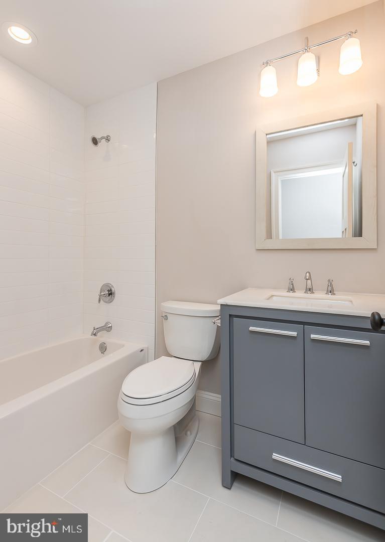 111 West Montgomery Avenue, Unit 107 Ardmore, PA 19003 - Photo 25 of 44 a bathroom with a toilet a sink a mirror and bathtub