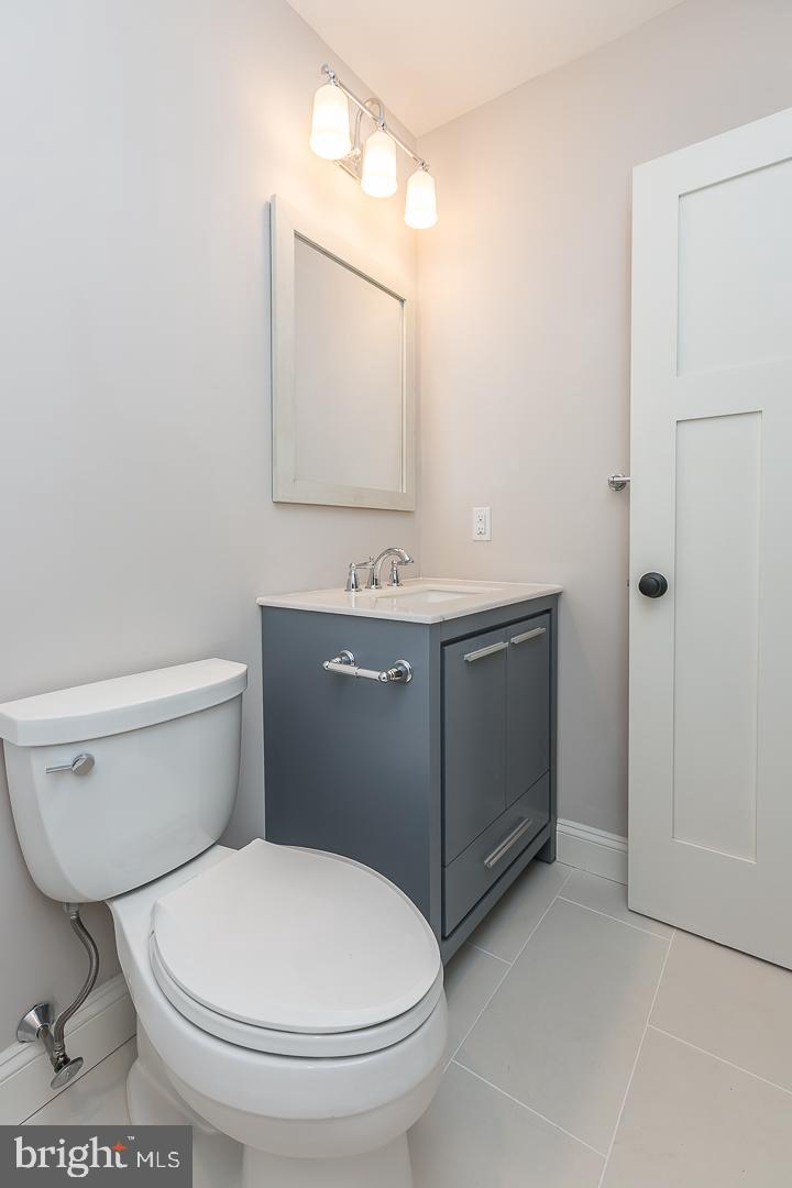 111 West Montgomery Avenue, Unit 107 Ardmore, PA 19003 - Photo 26 of 44 a bathroom with a toilet a sink and mirror
