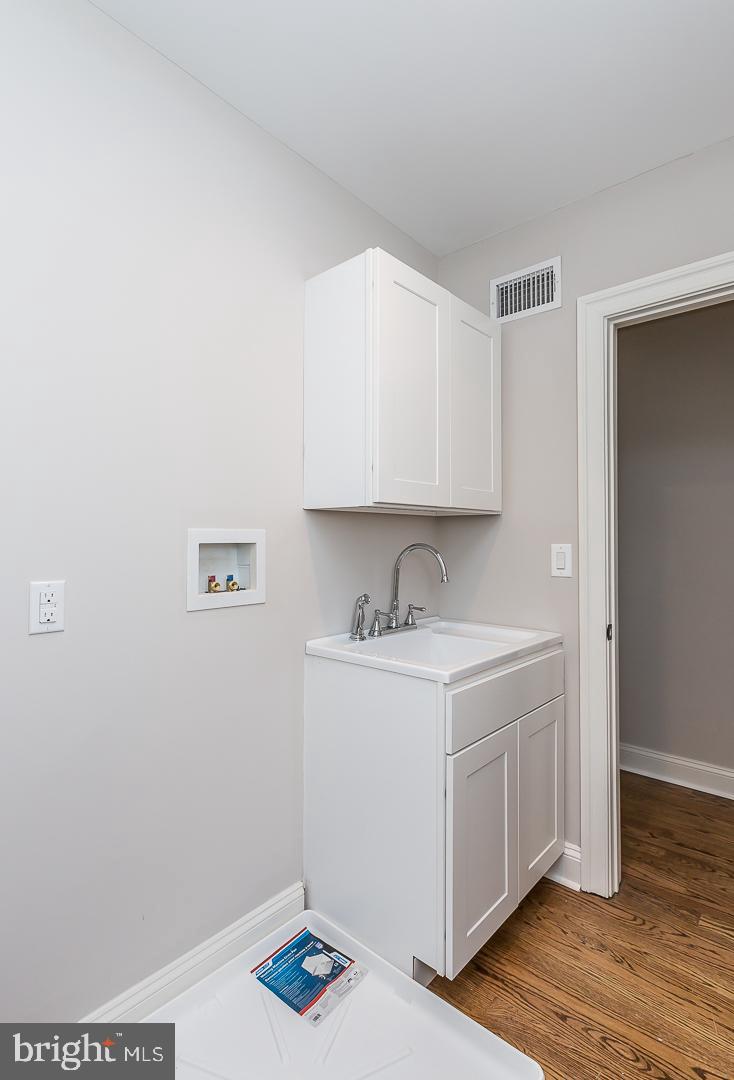 111 West Montgomery Avenue, Unit 107 Ardmore, PA 19003 - Photo 27 of 44 a kitchen with a sink cabinets and wooden floor