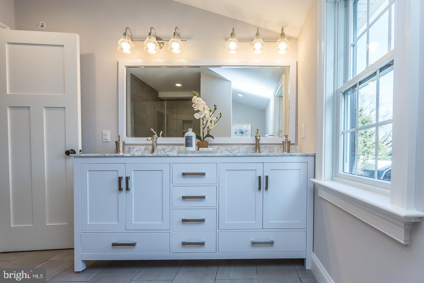 111 West Montgomery Avenue, Unit 107 Ardmore, PA 19003 - Photo 33 of 44 a bathroom with a sink and a mirror