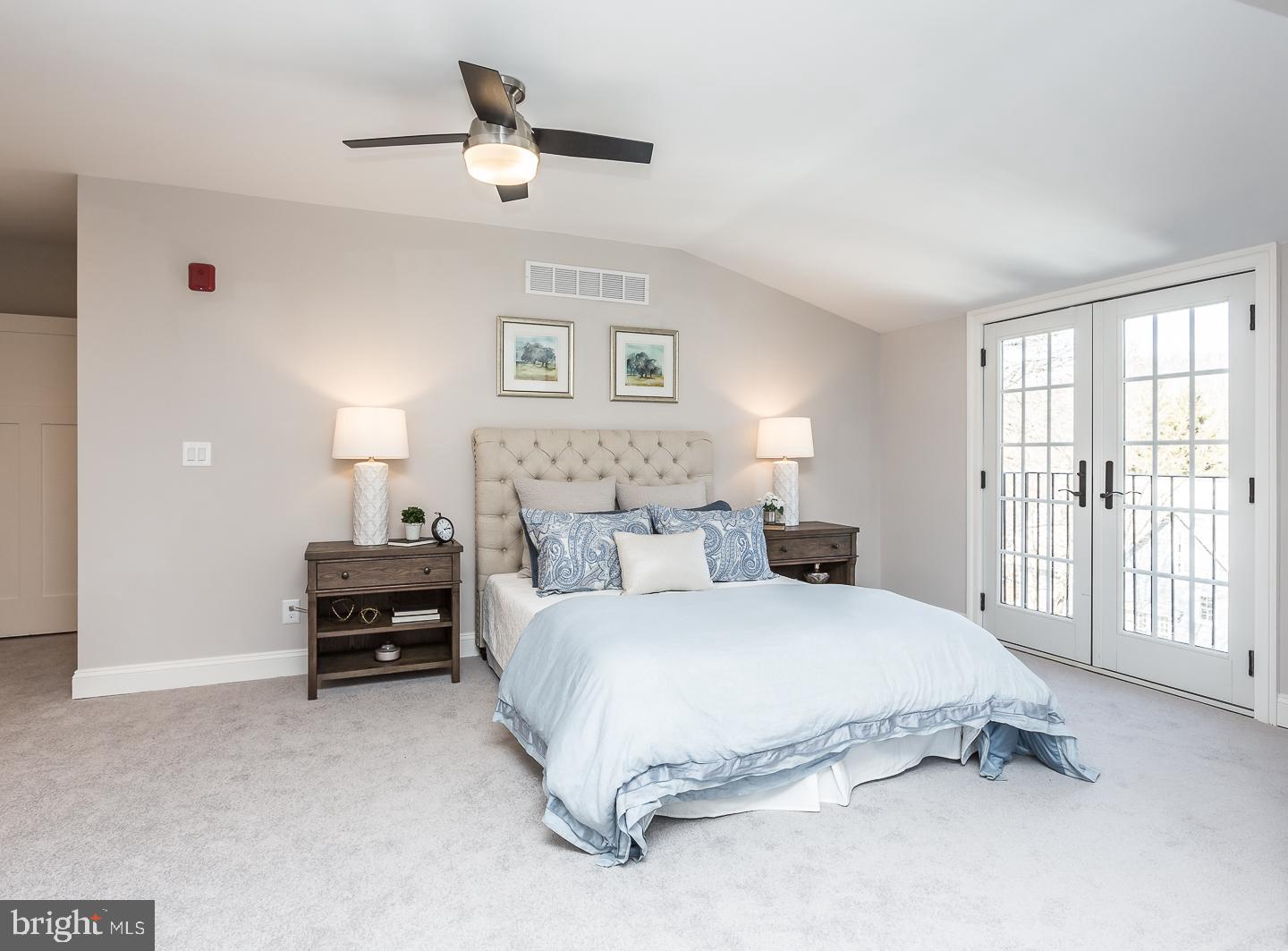 111 West Montgomery Avenue, Unit 107 Ardmore, PA 19003 - Photo 36 of 44 a spacious bedroom with a bed a couch and a window