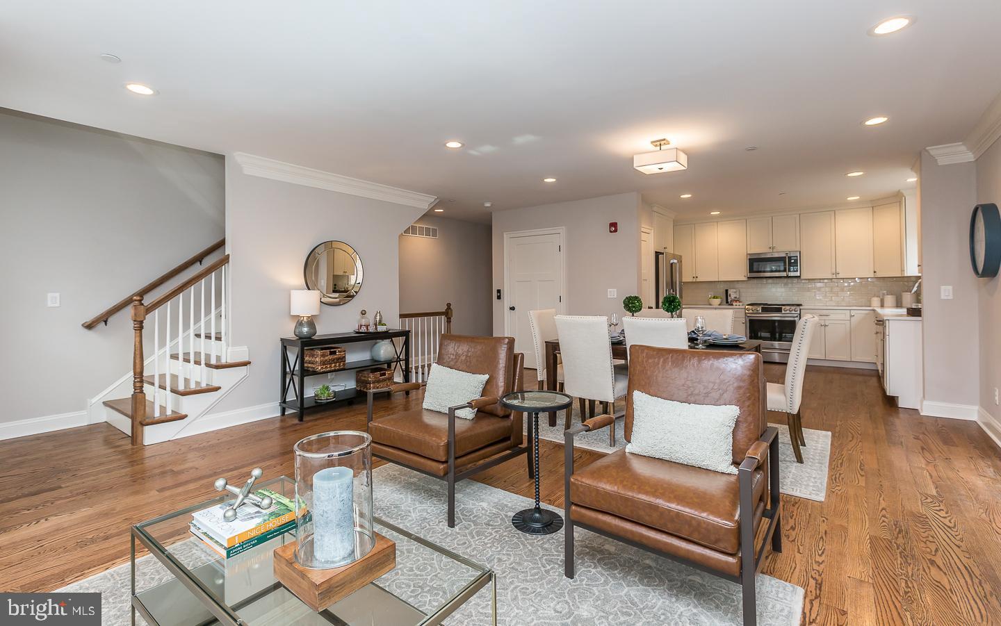 111 West Montgomery Avenue, Unit 107 Ardmore, PA 19003 - Photo 5 of 44 a living room with furniture and kitchen view