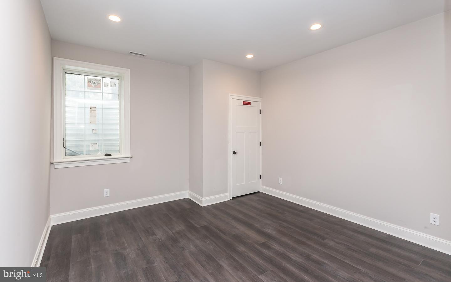 111 West Montgomery Avenue, Unit 107 Ardmore, PA 19003 - Photo 41 of 44 an empty room with wooden floor and windows