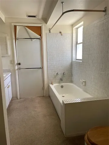 a bathroom with a sink a mirror and a bathtub