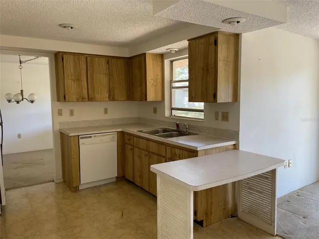 a kitchen with a stove a sink and a refrigerator