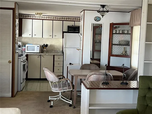 a kitchen with stainless steel appliances granite countertop a sink and a refrigerator