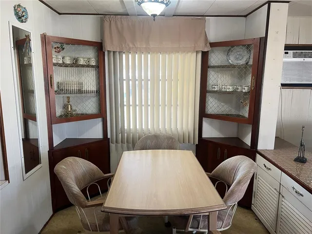 a view of a dining room with furniture and window