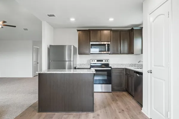 a kitchen with stainless steel appliances a refrigerator stove a sink and a microwave