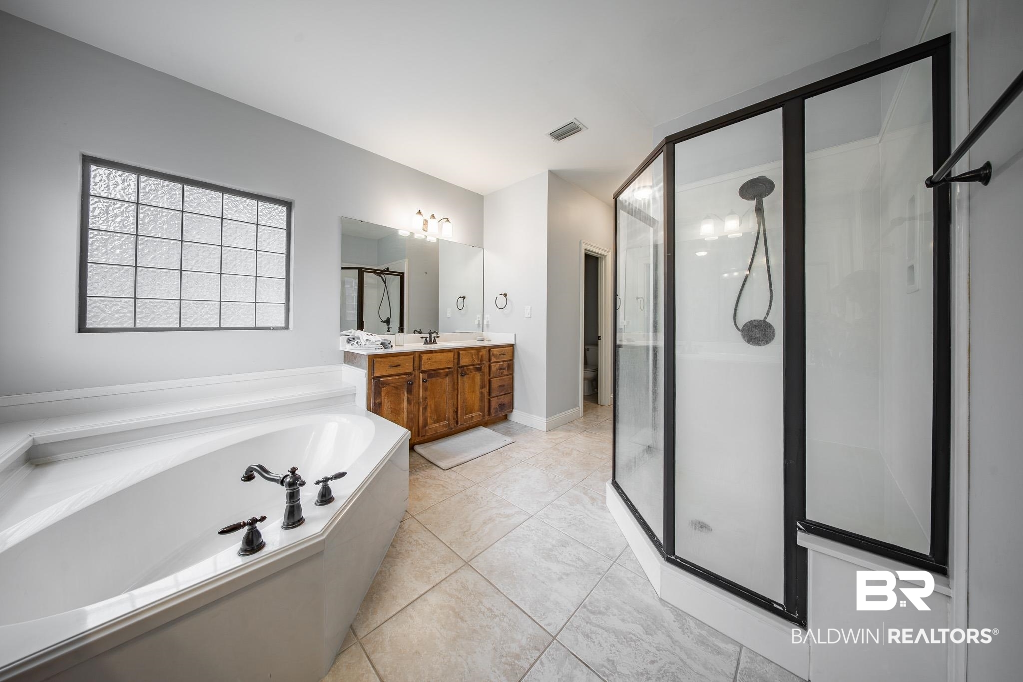 8421 Weatherford Court Daphne, AL 36527 - Photo 20 of 36 Full bath featuring vanity, a stall shower, and a garden tub