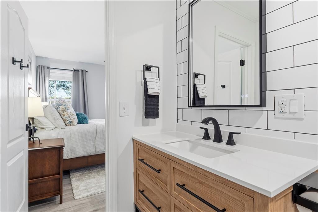549 Old Phoenix Road Northeast, Unit 104 Eatonton, GA 31024 - Photo 28 of 48 a bathroom with a sink and a mirror