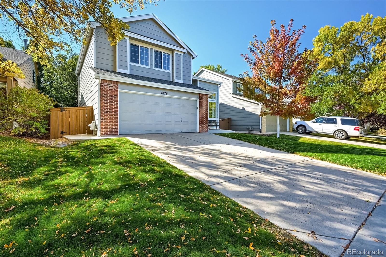 1076 Timbervale Trail Highlands Ranch, CO 80129 - Photo 1 of 29 a front view of a house with a yard and garage