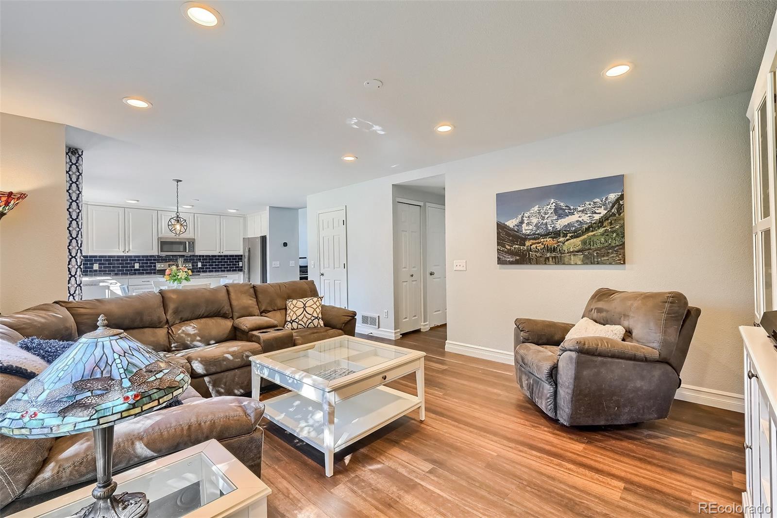 1076 Timbervale Trail Highlands Ranch, CO 80129 - Photo 11 of 29 a living room with furniture and wooden floor