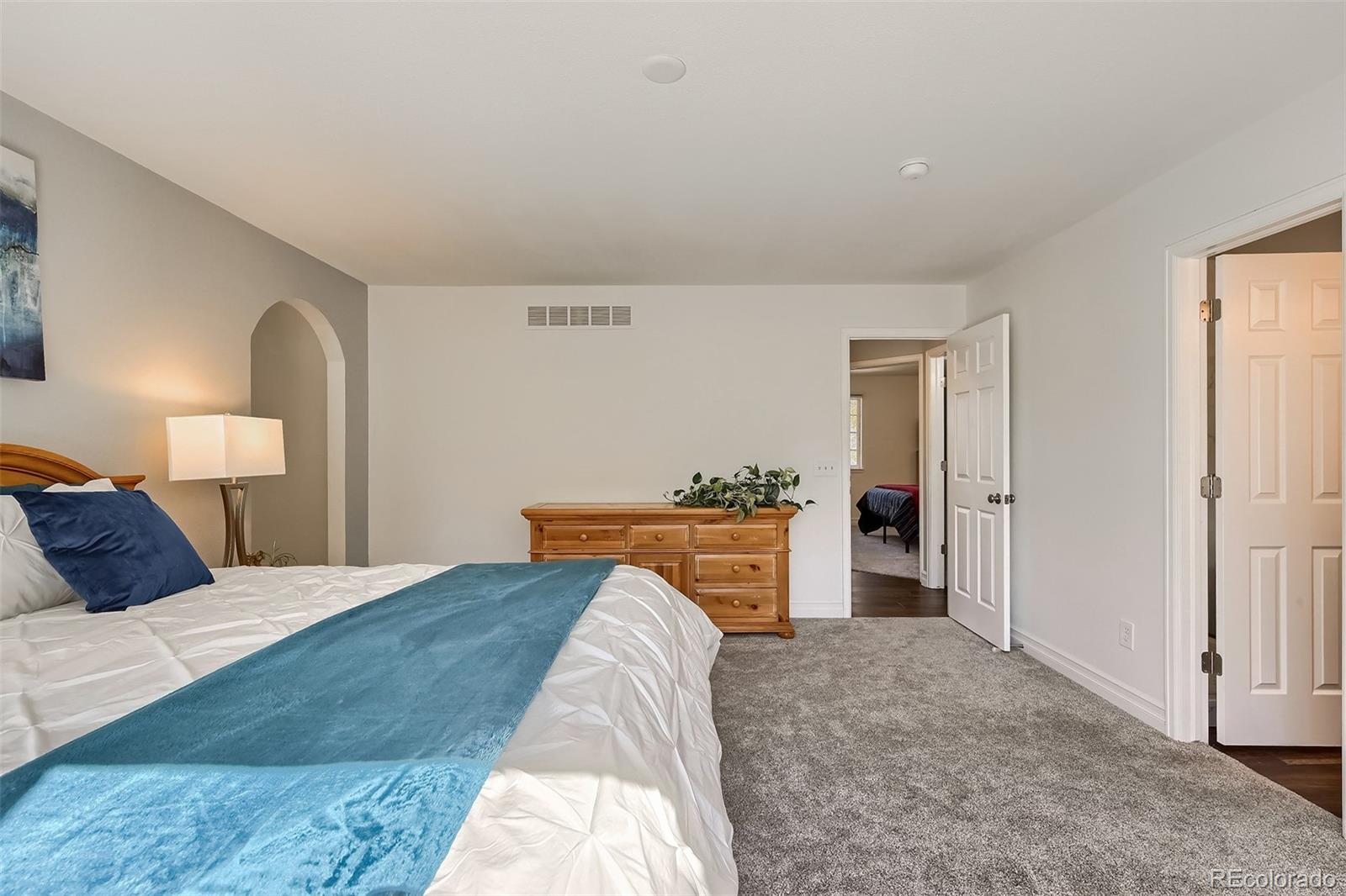 1076 Timbervale Trail Highlands Ranch, CO 80129 - Photo 16 of 29 a bedroom with a bed and a desk