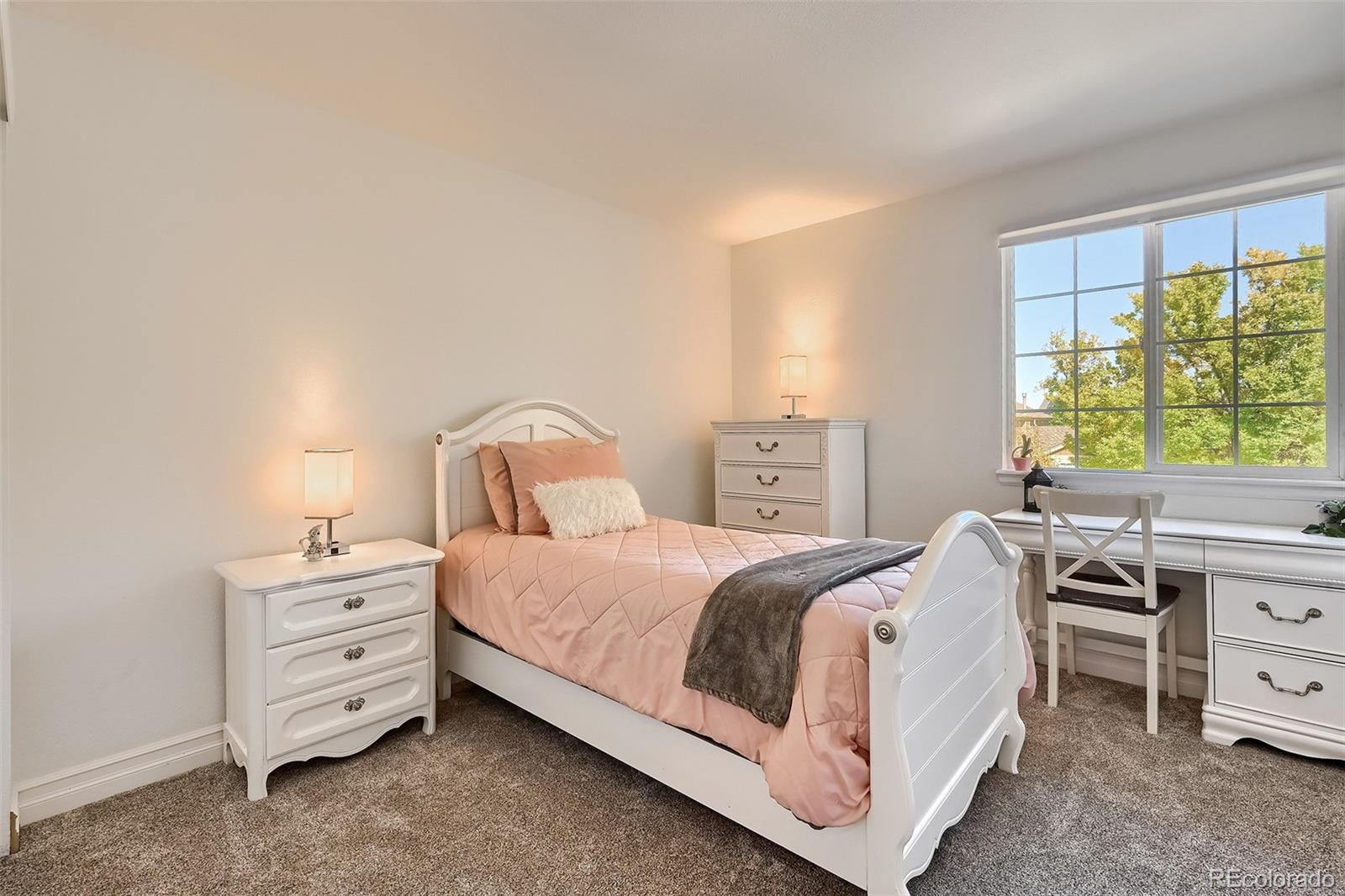 1076 Timbervale Trail Highlands Ranch, CO 80129 - Photo 20 of 29 a bedroom with a bed and a desk