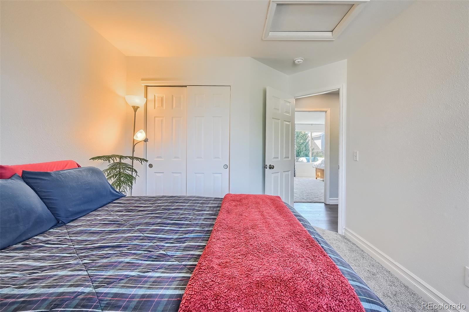 1076 Timbervale Trail Highlands Ranch, CO 80129 - Photo 23 of 29 a bedroom with a bed and a potted plant