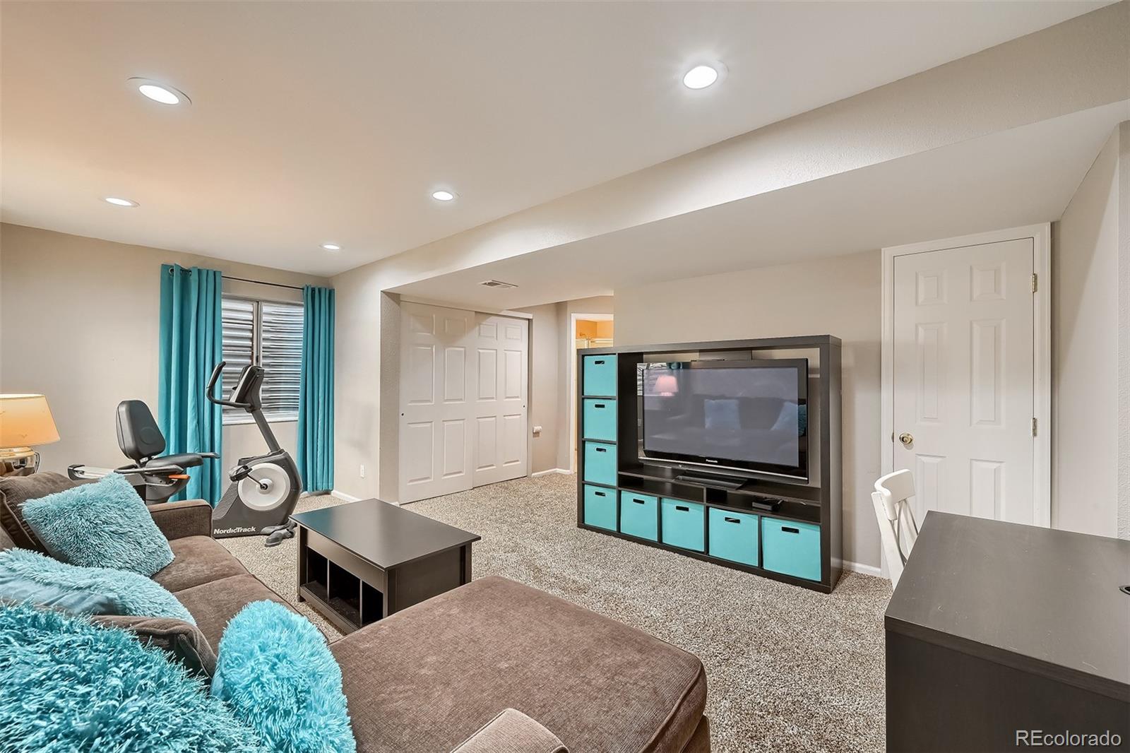 1076 Timbervale Trail Highlands Ranch, CO 80129 - Photo 25 of 29 a living room with furniture and a flat screen tv