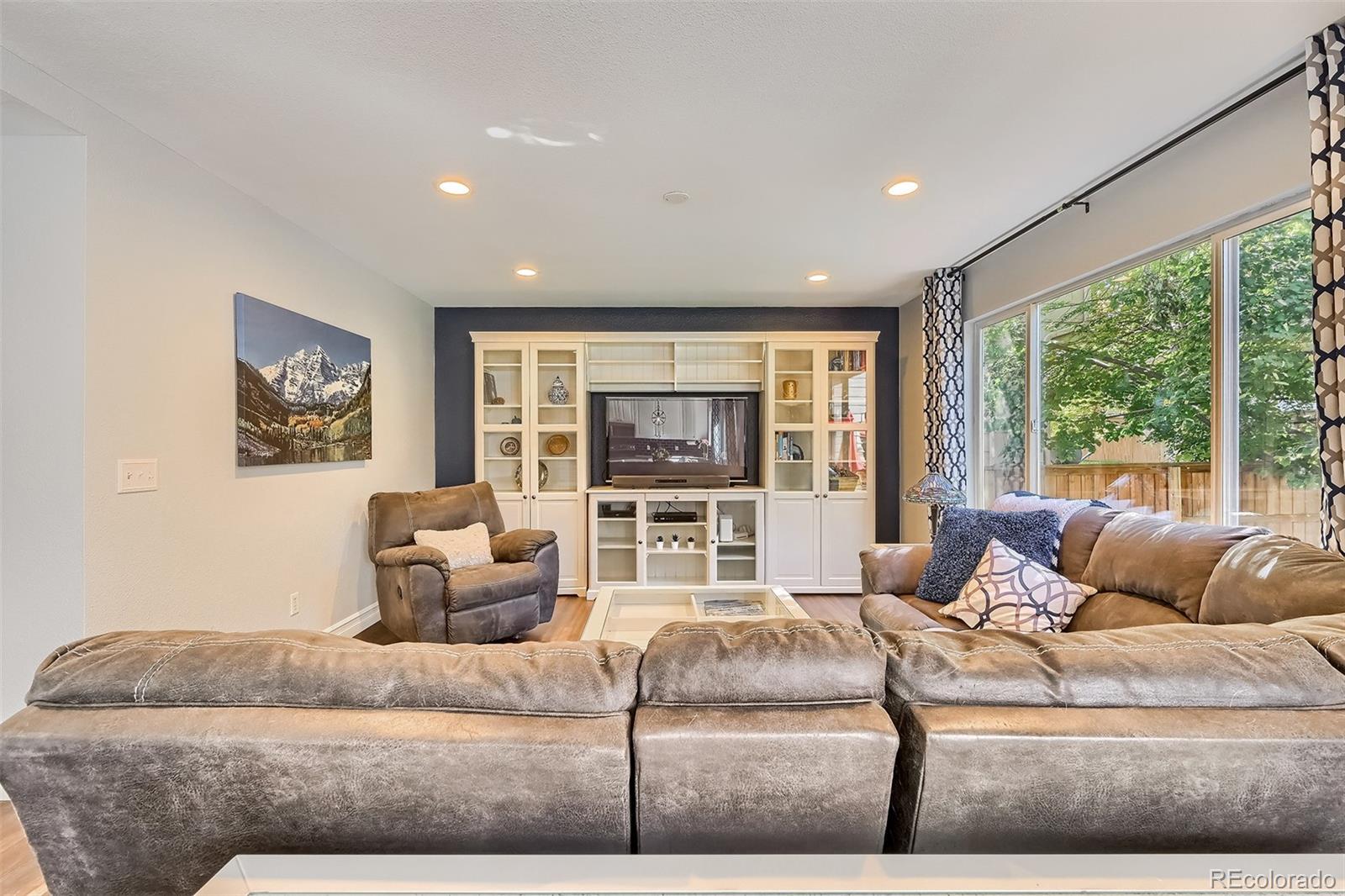 1076 Timbervale Trail Highlands Ranch, CO 80129 - Photo 9 of 29 a living room with furniture and a flat screen tv