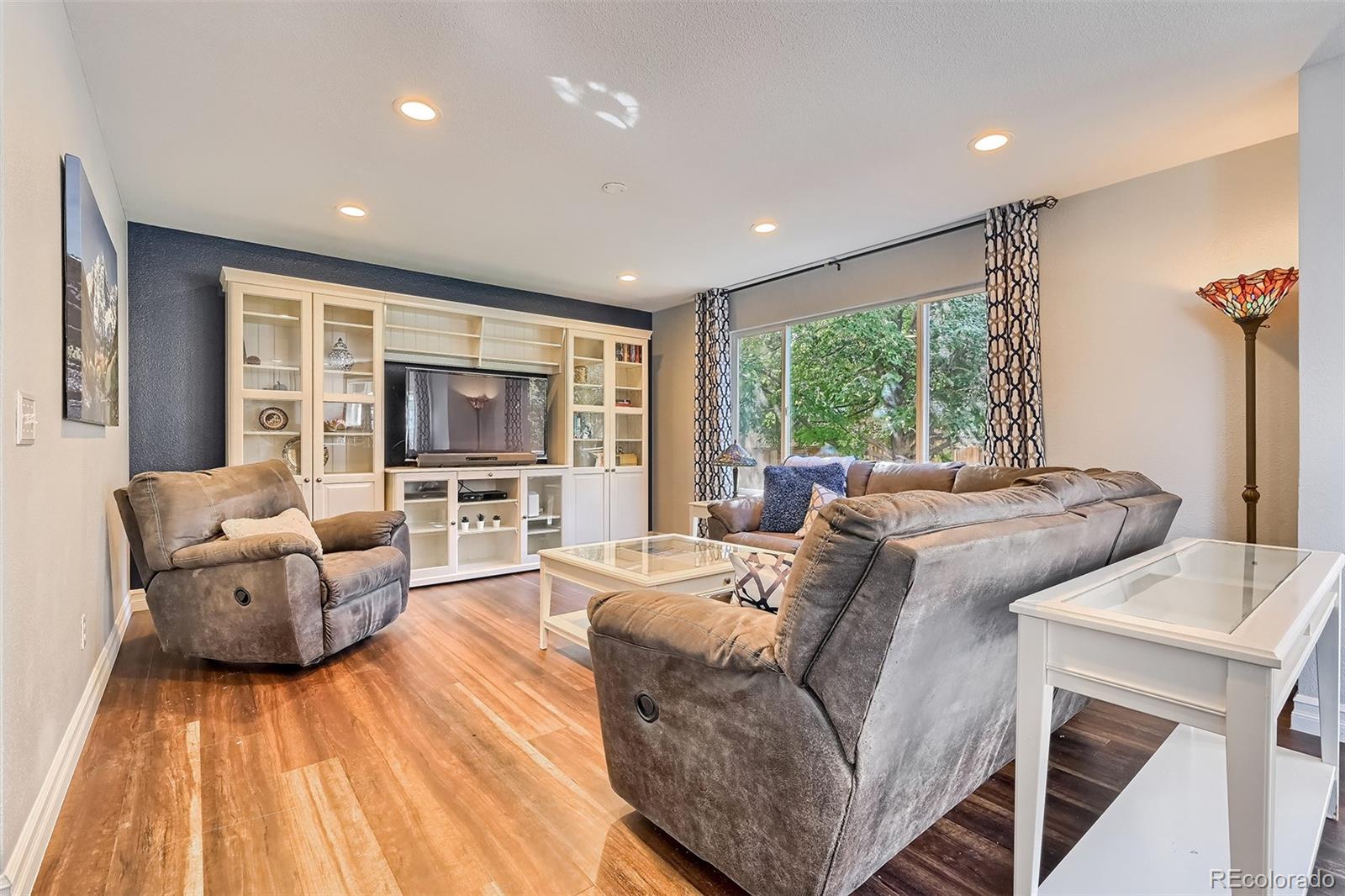 1076 Timbervale Trail Highlands Ranch, CO 80129 - Photo 10 of 29 a living room with furniture and a large window