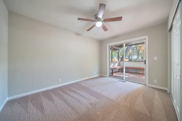 a view of room with window and ceiling fan