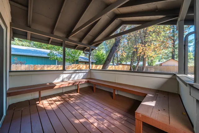 a balcony with wooden floor and furniture
