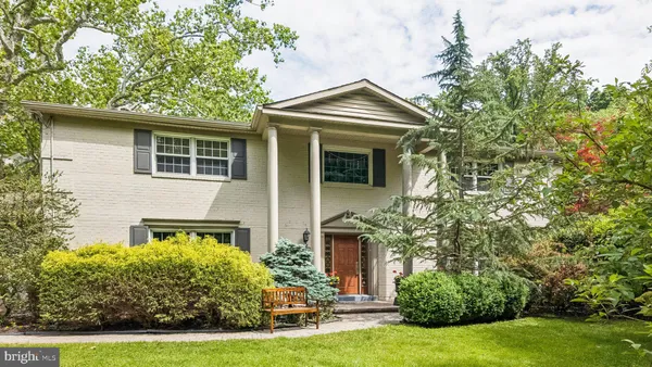 a front view of a house with yard and green space