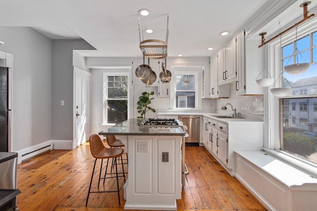 28 Wave Street, Unit 2 Lynn, MA 01902 - Photo 11 of 36 a kitchen with stainless steel appliances granite countertop a stove and cabinets