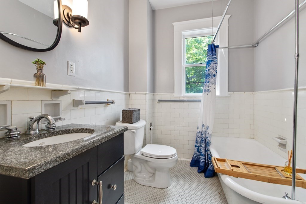 28 Wave Street, Unit 2 Lynn, MA 01902 - Photo 19 of 36 a bathroom with a granite countertop sink toilet and shower