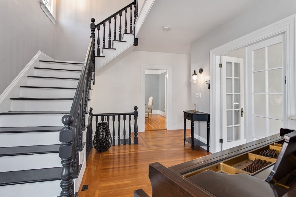 28 Wave Street, Unit 2 Lynn, MA 01902 - Photo 5 of 36 a living room with wooden floor and a dining table