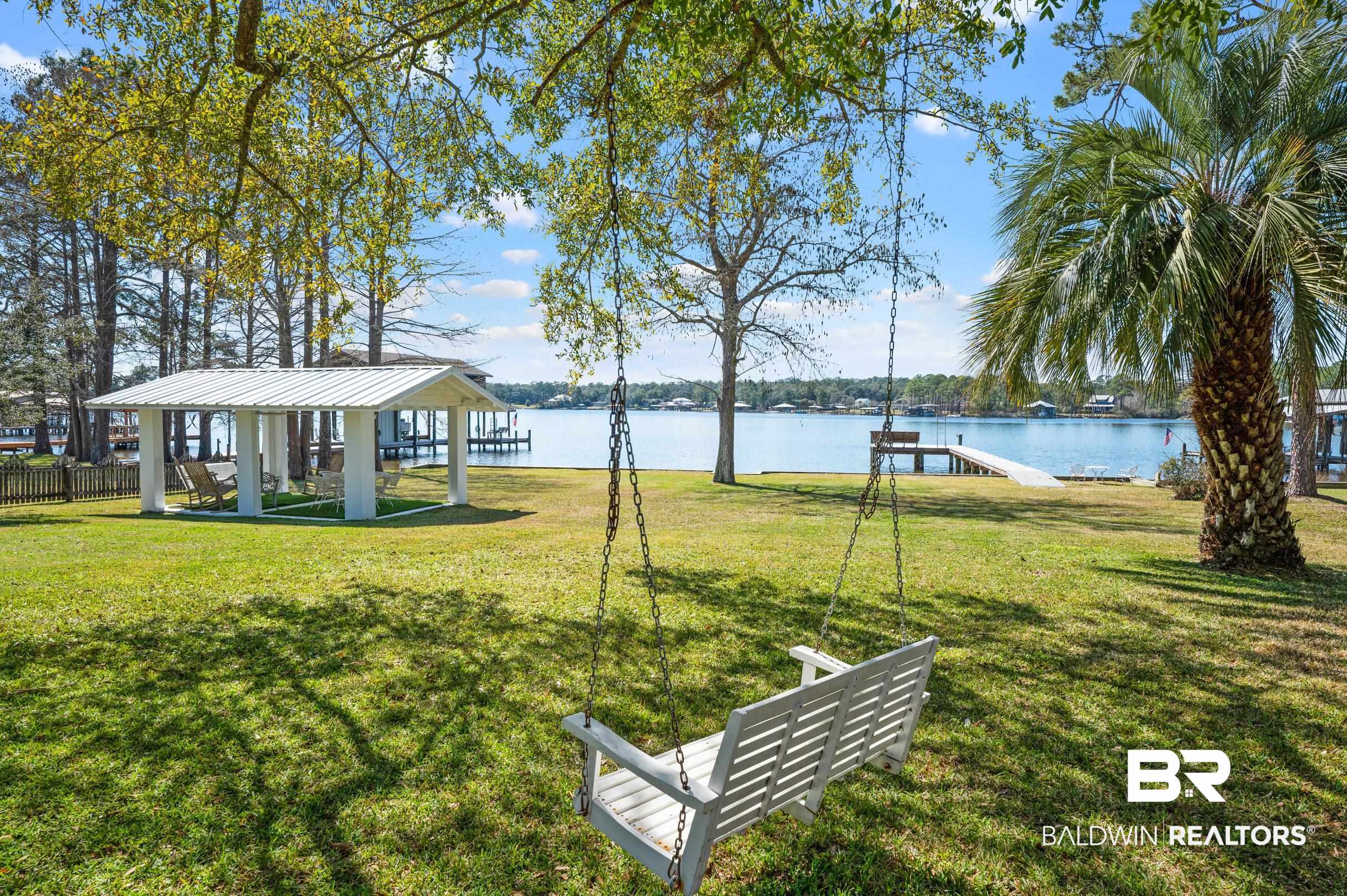 9459 Soldier Creek Road Lillian, AL 36549 - Photo 30 of 54 View of yard with a dock, a water view, and a gazebo